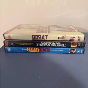 Stack of 3 DVD Movies – blue, black, cream spines